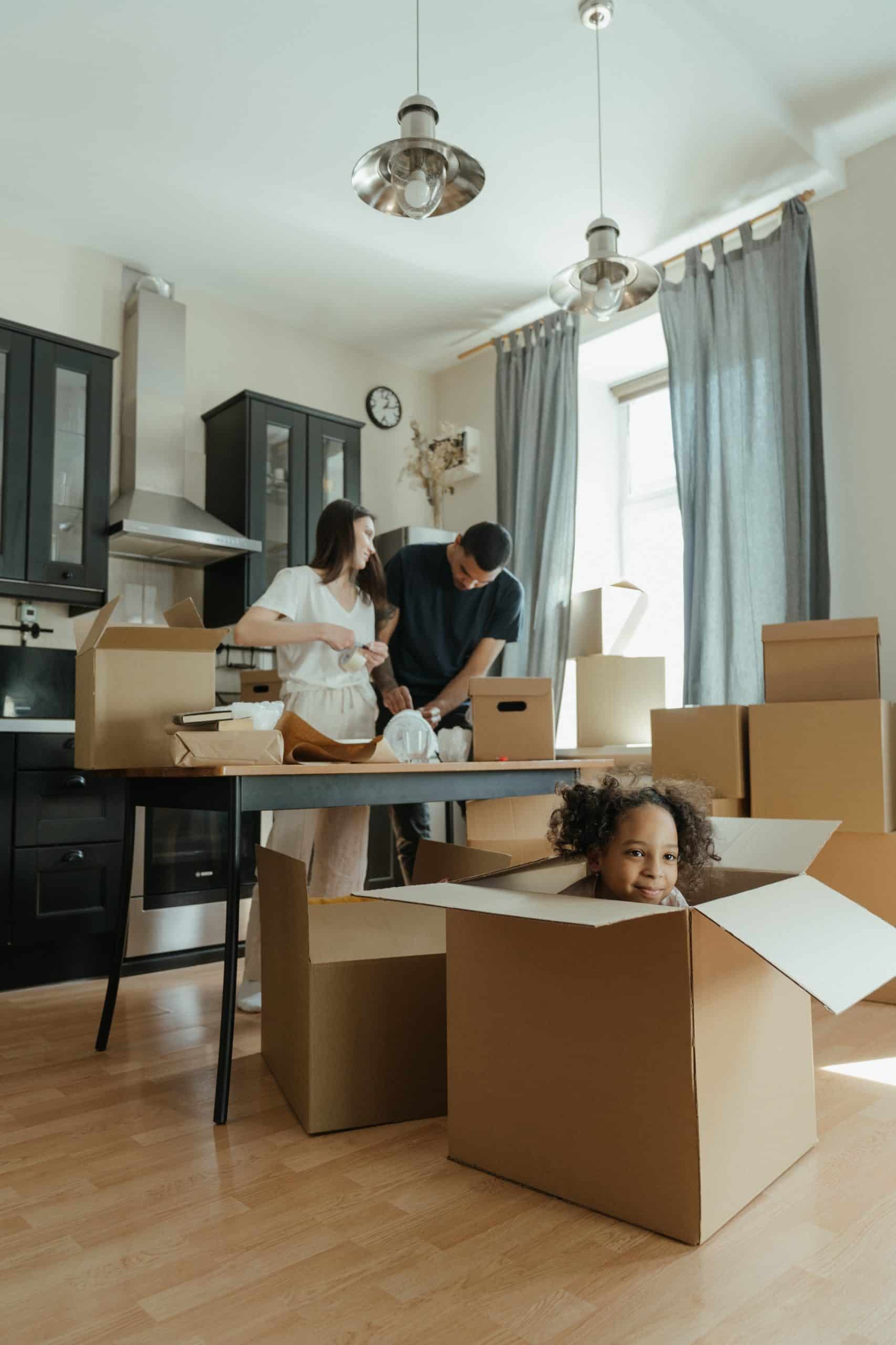 A family unpacking and moving into the new home they purchased.